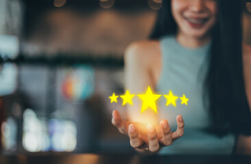 Happy Businesswoman customer experience concept, raising 5 stars to emphasize satisfaction with excellent service.