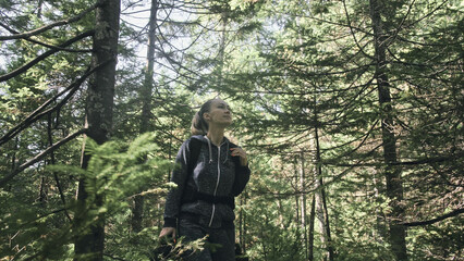 Traveler photographing scenic view in forest. One caucasian woman shooting nice magic look. Girl take photo video on dslr mirrorless camera. Professional photographer travel with backpack. Outdoor.