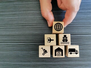 Delivery service concept with icons on wooden cubes.