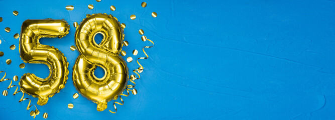 golden foil balloon number fifty eight. Birthday or anniversary card with the inscription 58. blue...