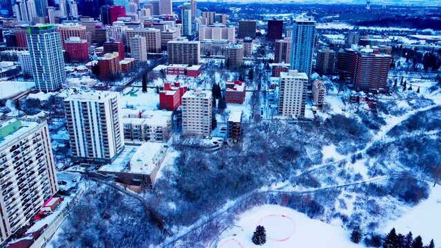 Edmonton Winter Aerial flyover birds view over new developments residential downtown rental apartments condominiums schools parks Government buildings revitalization during a snowy cold afternoon1-2