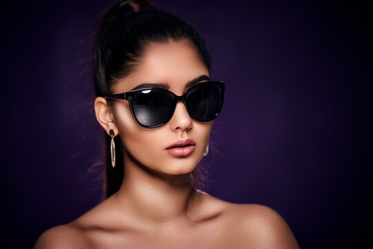 fashion portrait of beautiful Indian woman who wearing sunglasses and earrings. Asian glamour