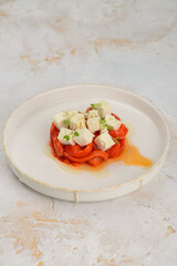 salad with pepper and cheese in a white plate
