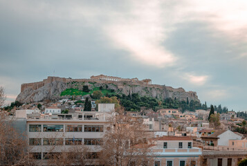 Fototapeta na wymiar Scenic view of the Acropolis and the historic district of Plaka, in Athens, Greece. Dramatic evening sky in the winter.