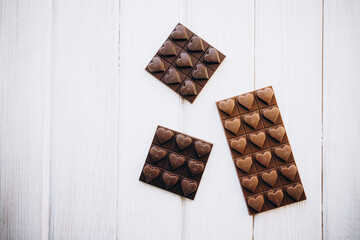 craft homemade milk and dark chocolate on a white wooden background