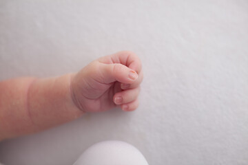 Little newborn baby fingers birth concept on white background