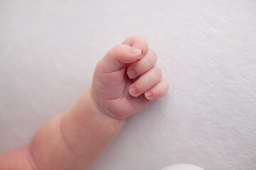 Little newborn baby fingers birth concept on white background
