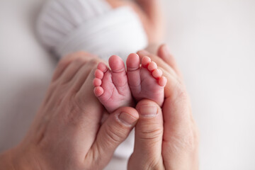Baby little feet and toes on white background 