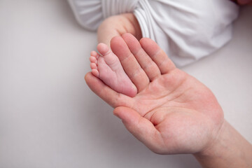Baby little feet and toes on white background 