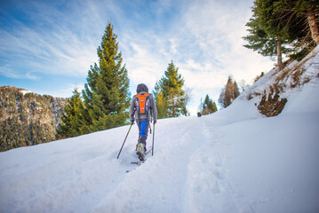 A child with ski touring uphill