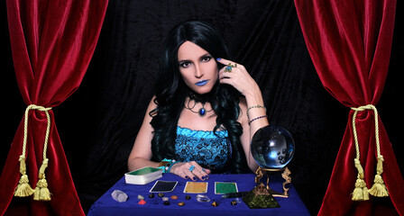 Psychic with Crystal Ball and tarot cards in Red Velvet Tent