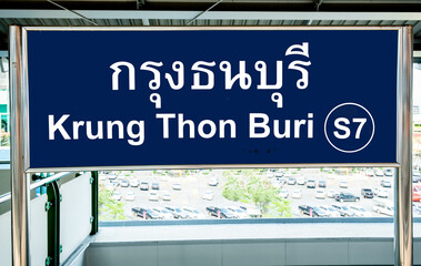 Sign in Thai and English languages on a station platform on the Bangkok BTS Skytrain