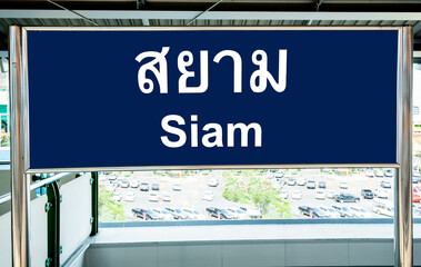 Sign in Thai and English languages on a station platform on the Bangkok BTS Skytrain