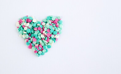 A valentine made of multicolored confetti on a white background. Greeting card