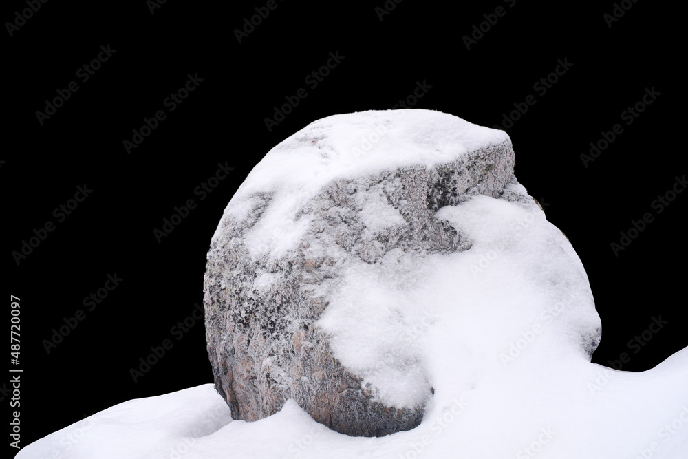 Sticker natural stone in snow isolated on black background