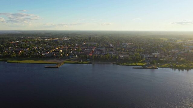 Aerial view of the Torniojoki river and the Haaparanta city, summer evening at the Finland Sweden border - tracking, drone shot