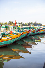 Fototapeta na wymiar Sightseeing boat cruises up and down the river in Hoi An