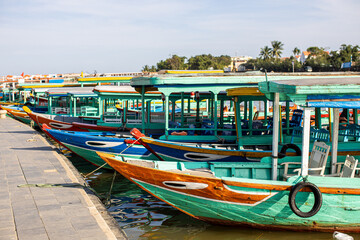 Fototapeta na wymiar Sightseeing boat cruises up and down the river in Hoi An