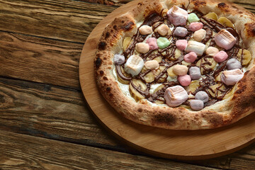 Whole sweet pizza served with marshmallows and candies