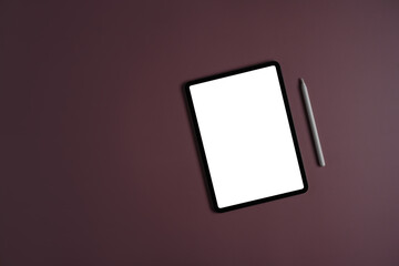 Flat lay mockup digital tablet with white empty screen and stylus pen on purple background.