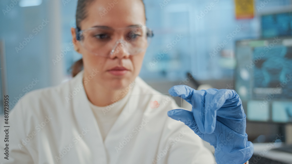 Poster close up of biologist analyzing blood sample on lab glassware for science experiment in laboratory. 