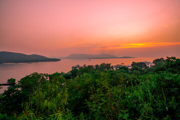 The background of the sea by the evening sea, with natural beauty (sea water, rocks, sky) and fishermen are fishing by the river bank, is a pleasure during travel.