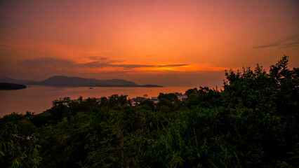 The background of the sea by the evening sea, with natural beauty (sea water, rocks, sky) and fishermen are fishing by the river bank, is a pleasure during travel.