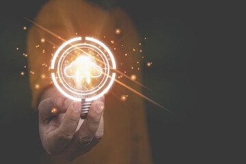 Businessman holding light bulb with cloud computing on hands with copy space. Security database and digital networking, the technology of business to the future concept.