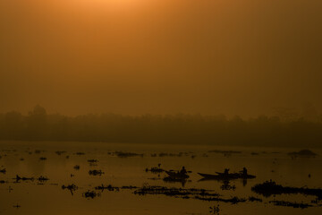 The background of the sea by the evening sea, with natural beauty (sea water, rocks, sky) and fishermen are fishing by the river bank, is a pleasure during travel.