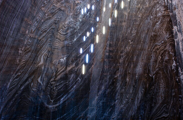 salt mine wall with suspended lights, Turda salt mine, Romania