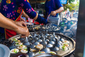 Vietnamese savory mini shrimp pancakes (Banh Khot) with herbs, eggs, shrimps and fish Sauce -...