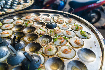 Vietnamese savory mini shrimp pancakes (Banh Khot) with herbs, eggs, shrimps and fish Sauce - Vietnamese cuisine.