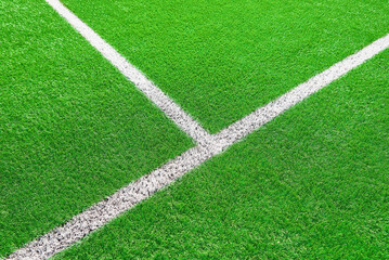 Part of football or soccer field close up, Artifical green grass with white border lines, Astroturf...