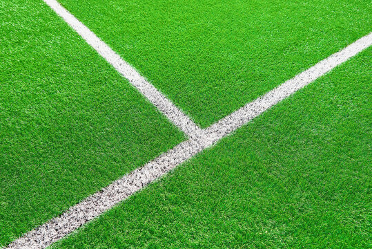 Part of football or soccer field close up, Artifical green grass with white border lines, Astroturf at stadium for spart games