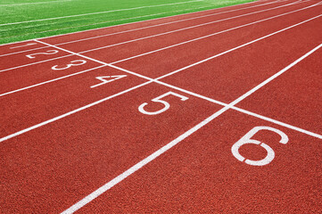 Red runninng race track with lane numbers closeup, Treadmill at stadium, Summer sport and fitness concept