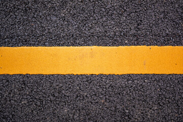 Fototapeta premium Asphalt road surface with yellow line background