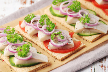 Sandwiches with herring and vegetables	