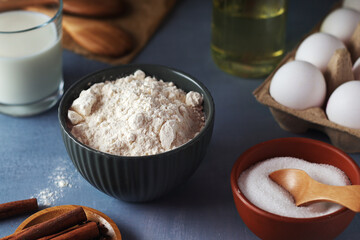 Food ingredients for baking: flour, eggs, milk, sugar	