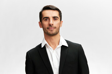 white man in a black business suit looking at the camera successful businessman on a light isolated background