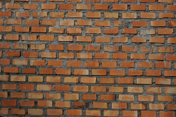 Obraz premium close up photo of brick wall looks original texture of cement and orange bricks, nice wallpaper