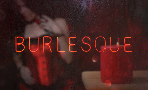 Neon Burlesque Sign in Rainy Wet Window