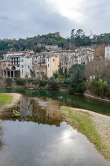 Fototapeta na wymiar Sauve, medieval village in France, view of typical houses, reflection on the river 