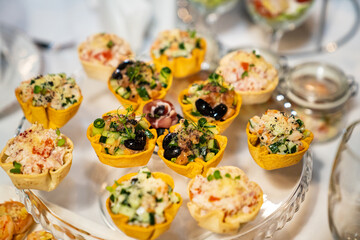 tartlets with salads. convenient serving of snacks for the buffet. catering for the holiday.