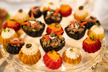 tartlets from custard dough with salads. convenient serving of snacks for the buffet. catering for the holiday.