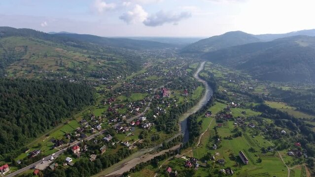 Beautiful aerial video of a small town in the mountains in summer on a bright sunny day