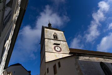 Beautiful collegiate church at little medieval town St-Ursanne, Canton Jura, on a sunny winter day....
