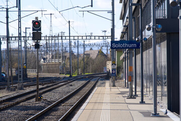 Platform at railway station Solothurn with modern glass roof on a sunny winter day. Photo taken February 7th, 2022, Solothurn, Switzerland.