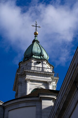 Fototapeta premium Historic colorful house facades at medieval alley with cathedral St. Ursen in the background at the old town of Solothurn on a sunny winter day. Photo taken February 7th, 2022, Solothurn, Switzerland.