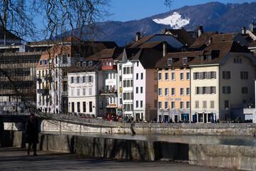 Fototapeta na wymiar View at the old town of Solothurn seen form the Kreuzacker Bridge on a sunny winter day with river Aare in the foreground. Photo taken February 7th, 2022, Solothurn, Switzerland.