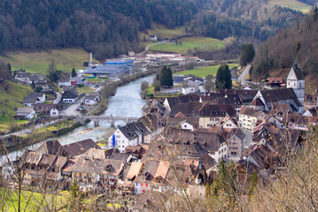 Aerial view of small medieval town St-Ursanne with river Doubs on a cloudy winter day. Photo taken...